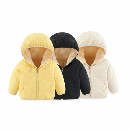 Three children's puffer jackets in yellow, black, and white arranged in a line